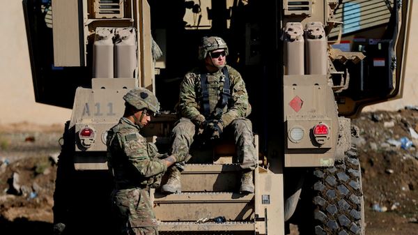 US army soldiers sit next a military vehicle in the town of Bartella, east of Mosul, Iraq, December 27, 2016. Picture taken December 27, 2016. REUTERS/Ammar Awad - RTX2XLTE